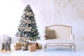 Large white living room with a vintage sofa and a large Christmas tree Royalty Free Stock Photo