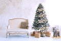 large white living room with a vintage sofa and a large Christmas tree Royalty Free Stock Photo