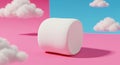 A large, white marshmallow is placed on a pink surface with a blue and pink Royalty Free Stock Photo
