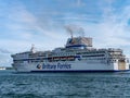 A large white passenger ferryboat sails on the sea, summer. Blue sky with white clouds over a sea