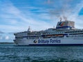 A large white passenger ferryboat sails on the sea on a summer evening. Blue sky with white clouds