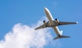 A large white passenger plane takes off. Cargo and passenger transportation. Flight to the summer resort. Clear blue sky. Airplane Royalty Free Stock Photo