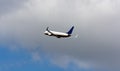 A large white passenger plane takes off. Cargo and passenger transportation. Flight to the summer resort. Clear blue sky. Airplane Royalty Free Stock Photo