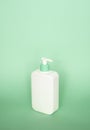 Large white plastic bottle with pump dispenser as a liquid container for gel, lotion, cream, shampoo, bath foam on pink Royalty Free Stock Photo