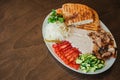 Large white plate with a selection of snacks and creamy sauce. Baked tortillas, tomatoes with cucumbers and cheese. Dark meat with Royalty Free Stock Photo