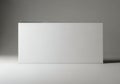 A large white rectangular object standing upright against a gray background Royalty Free Stock Photo