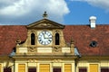 large white round clock in old yellows stucco exterior facade. architecture and travel concept Royalty Free Stock Photo