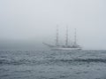 A large white sailboat floats on the sea through the strait Royalty Free Stock Photo