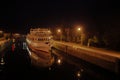 A large white ship with tourists stands in a lock on the Volga river, Russia