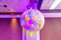 A large white transparent balloon with small multi-colored balloons inside Royalty Free Stock Photo