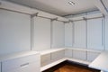 Large white walk-in closet with parquet