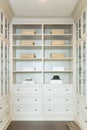 Large white walk-in closet with shelves Royalty Free Stock Photo