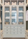 Large white walk-in closet with shelves