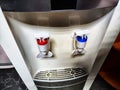 Large white water cooler with two taps. A soft serve machine with red and blue levers