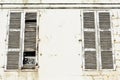 Large white weathered closed wooden window shutters