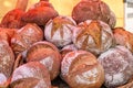 Wicker large basket with fresh brown homemade loaves of bread for sale at the market place Royalty Free Stock Photo