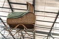 Large wicker pram hangs from the ceiling