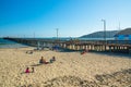 Large wide sandy beach and the Avila Beach pier which extends into the ocean from Avila Promenade