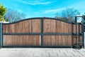 Large wide and tall wooden gate against a clear blue sky. Rustic Wood Background with Texture.