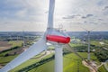 large wind farm with many wind turbines is built near a small town in northern Germany