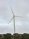 A large wind turbine moving to create kinetic energy for renewable energy supply Royalty Free Stock Photo