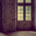 A large window between the brick walls in the old house