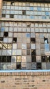Window with broken glass giving a view of a warehouse in the background Royalty Free Stock Photo