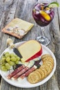 Large wine glass of red sangria with a cheese plate with appetizers Royalty Free Stock Photo