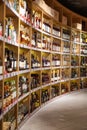 Large wine racks. Many different alcoholic beverages. Luxury enoteca. The photo is blurry Royalty Free Stock Photo