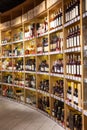 Large wine racks. Many different alcoholic beverages. Luxury enoteca. The photo is blurry Royalty Free Stock Photo