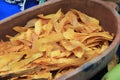 Large wood bowl filled with fresh slices of plantain chips