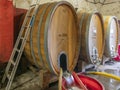 A large wooden barrel for aging wine is washed and disinfected in a Tuscan winery in the Chianti area Royalty Free Stock Photo