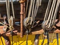 Large wooden blocks are attached to different ropes of a large sailing vessel Royalty Free Stock Photo