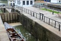 Large wooden boat set in water, ready for Lock to open and allow through, Lockport New York, 2018 Royalty Free Stock Photo