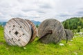 Large wooden cable pulleys with electric cables. Cable reels, cable drums lying on the construction site.