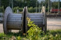 Large wooden cable reels on a construction site on the railway