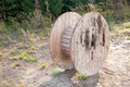 Large wooden cable spools stands on the ground Royalty Free Stock Photo