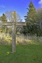 Wooden christian cross outdoors with forest background, blue sky and clouds Royalty Free Stock Photo