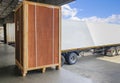 Large Wooden Crate Loading into Shipping Cargo Container. Truck Parked Loading at Dock Warehouse. Supply Chain Shipment Logistics. Royalty Free Stock Photo