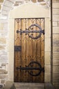 A large wooden door closed an old fortress in the stone wall of the castle in Germany on the Rhine River Royalty Free Stock Photo