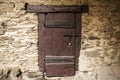 A large wooden door closed an old fortress in the stone wall of the castle in Germany on the Rhine River Royalty Free Stock Photo