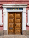 Large wooden door with the number 1 on the white door frame and the number 1805 above it Royalty Free Stock Photo