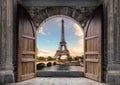 Large wooden door open with Eiffel Tower on Seine River on sunset at Paris Royalty Free Stock Photo