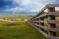 A large wooden fence on a private plot in the village of Shigaevo in the Southern Urals against the backdrop of mountains and Arvy Royalty Free Stock Photo