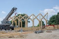 Large wooden framed building being constructed