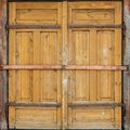 Large wooden gate is closed and metal rusty bolts. Preserving the history and architecture of the past. Log house Royalty Free Stock Photo