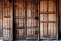 Large wooden medieval door with crossbars and bars.