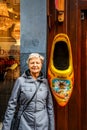 Large wooden shoe, painted in traditional Dutch pattern and colors, hanging outside souvenir shop in Amsterdam