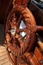 Large wooden steering wheel of a classical sailing yacht.