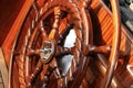 Large wooden steering wheel of a classical sailing yacht.